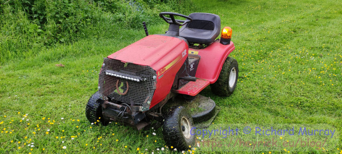 A photo of a delapidated ride-on mower
