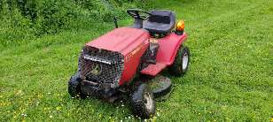 A photo of a delapidated ride-on mower