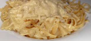 A plate of cheese-covered linguine.