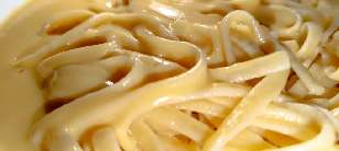 A close-up of linguine and butter sauce.