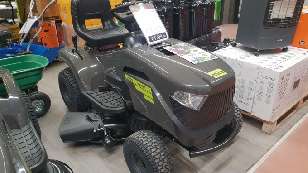 A grey ride-on lawnmower in the shop.