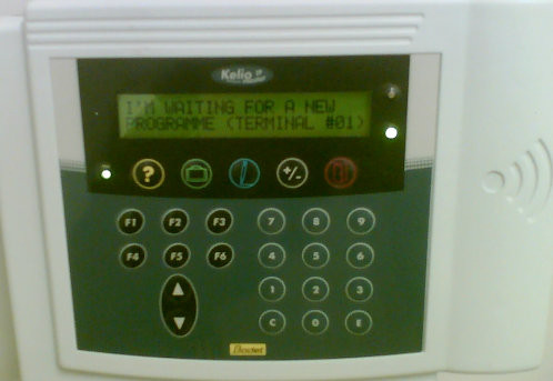 Our clocking in/out machine saying 'I'm waiting for a new programme' (sic)