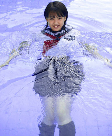 A schoolgirl in a pool