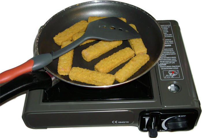 Making salmon fish fingers on the mini gas cooker.