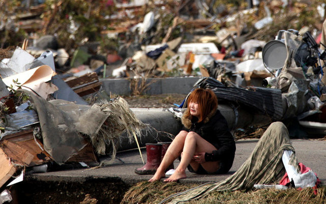 Natori, a woman alone in the wreckage, crying.