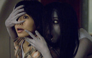 Screen capture from The Grudge 2 showing stringy haired ghost girl being menacing.