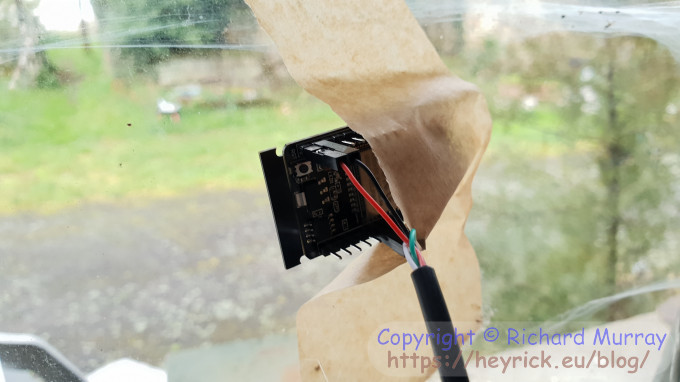 ESP32-CAM taped to window