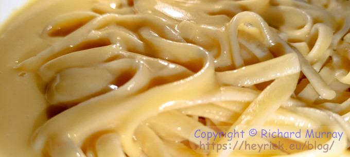 A close-up of linguine and butter sauce.