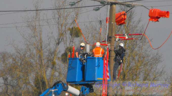 People working on an active 20kV power line.