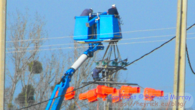 People working on an active 20kV power line.