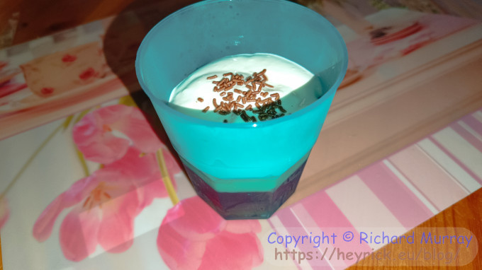 A mini-trifle in a plastic beaker.