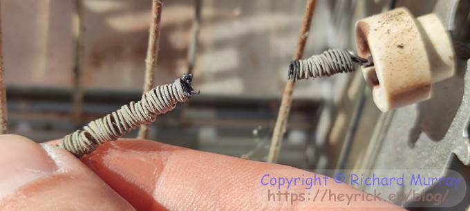 Two pieces of a broken heater element.