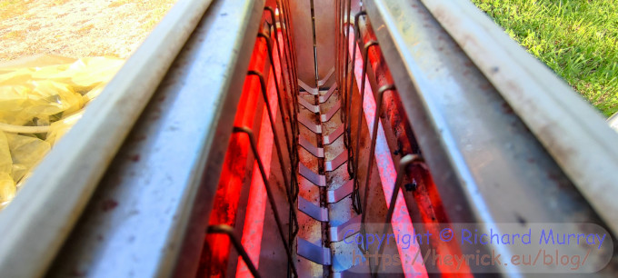Looking along the top of the toaster, the elements glowing bright red.