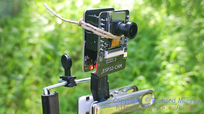An ESP32-Cam clipped to a tripod.