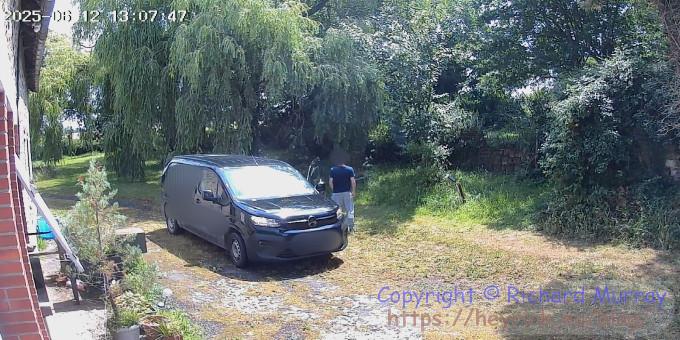 A delivery man standing by his truck to empty his bladder on my grass right out front.