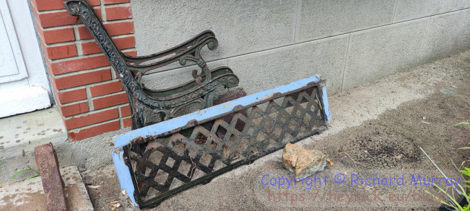 Parts of an iron and wood bench.