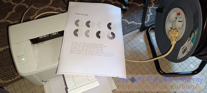 A compact laser printer sitting on the floor