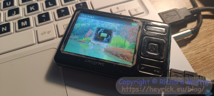 A Creative Zen media player sitting on my computer.