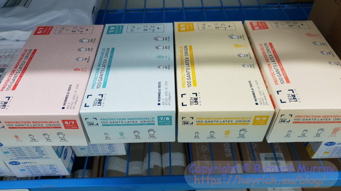 A photo of four boxes of differently sized latex gloves.