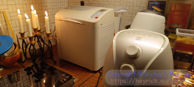 A breadmaker in the corner of the kitchen.