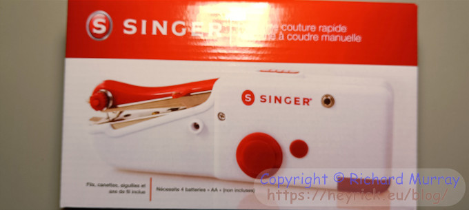 A box containing a little sewing machine.