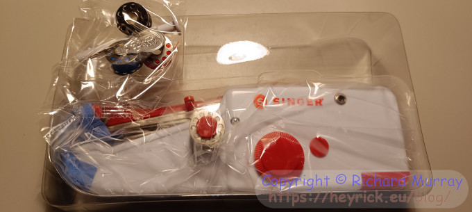 The little sewing machine and accoutrements in the box.