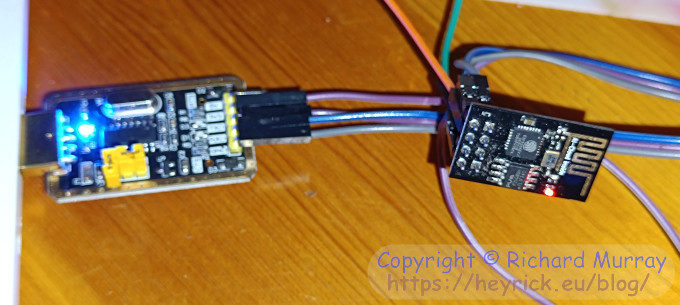 A tiny ESP8266 board connected to a USB serial interface.