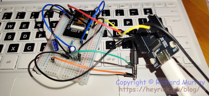 An ESP32 on a breadboard with lots of wires.